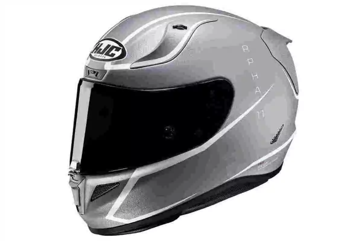 Casco de motocicleta color gris con visor oscuro y diseño aerodinámico Casco de motocicleta color gris con visor oscuro y diseño aerodinámico
