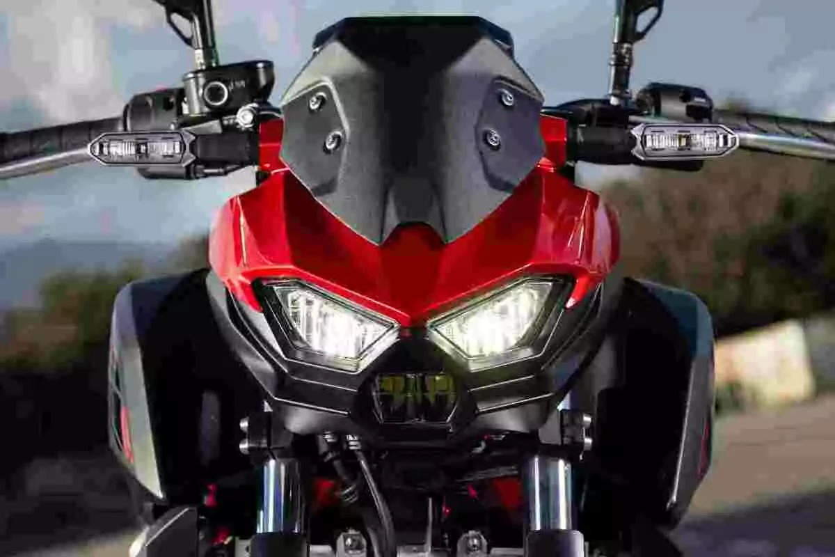 Red motorcycle seen from the front with headlights on and black details Red motorcycle seen from the front with headlights on and black details
