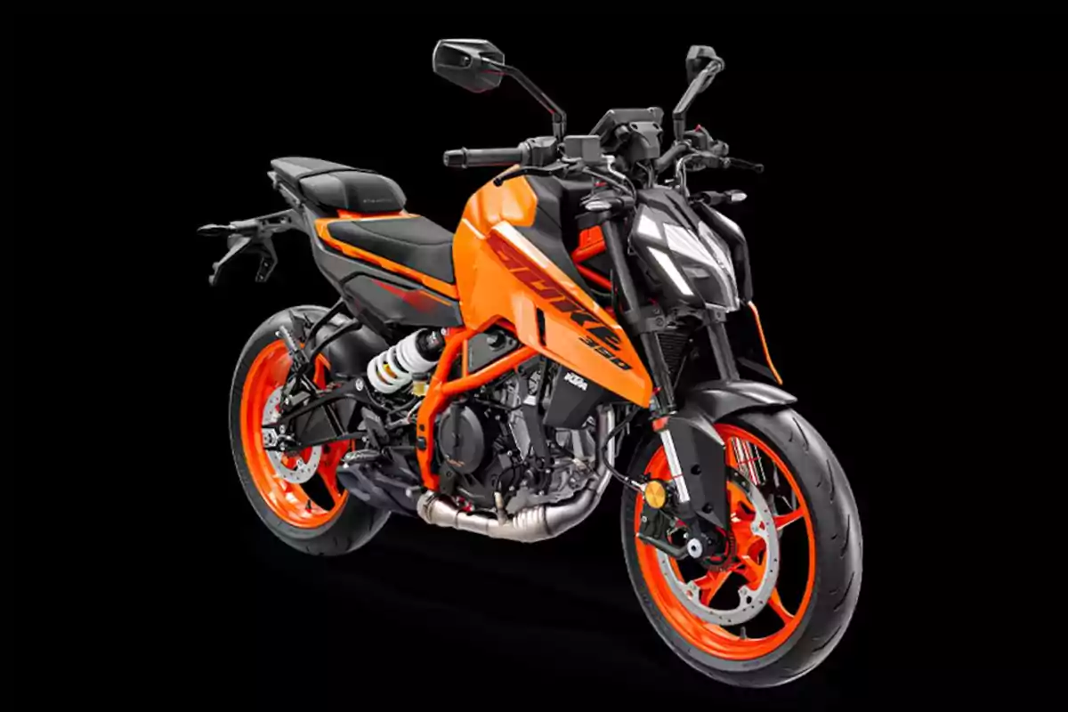 Motocicleta deportiva de color naranja y negro con detalles modernos sobre un fondo negro Motocicleta deportiva de color naranja y negro con detalles modernos sobre un fondo negro