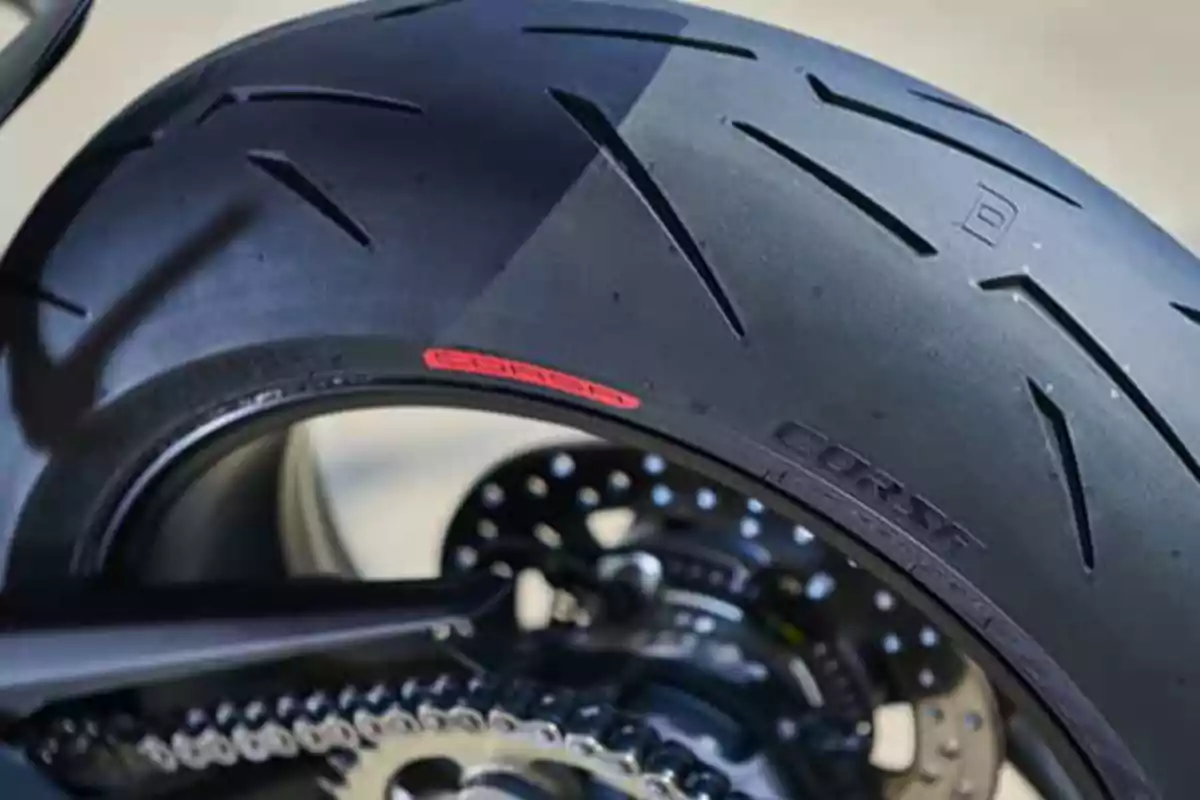 Rear tire of a sport motorcycle with high-performance tread pattern and visible chain Rear tire of a sport motorcycle with high-performance tread pattern and visible chain