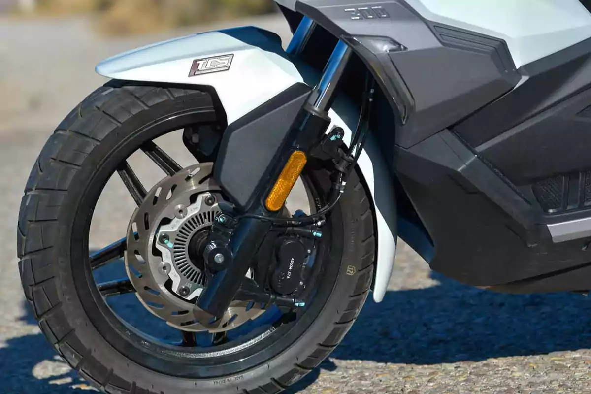Llanta delantera de una motocicleta con freno de disco y suspensión visible Llanta delantera de una motocicleta con freno de disco y suspensión visible