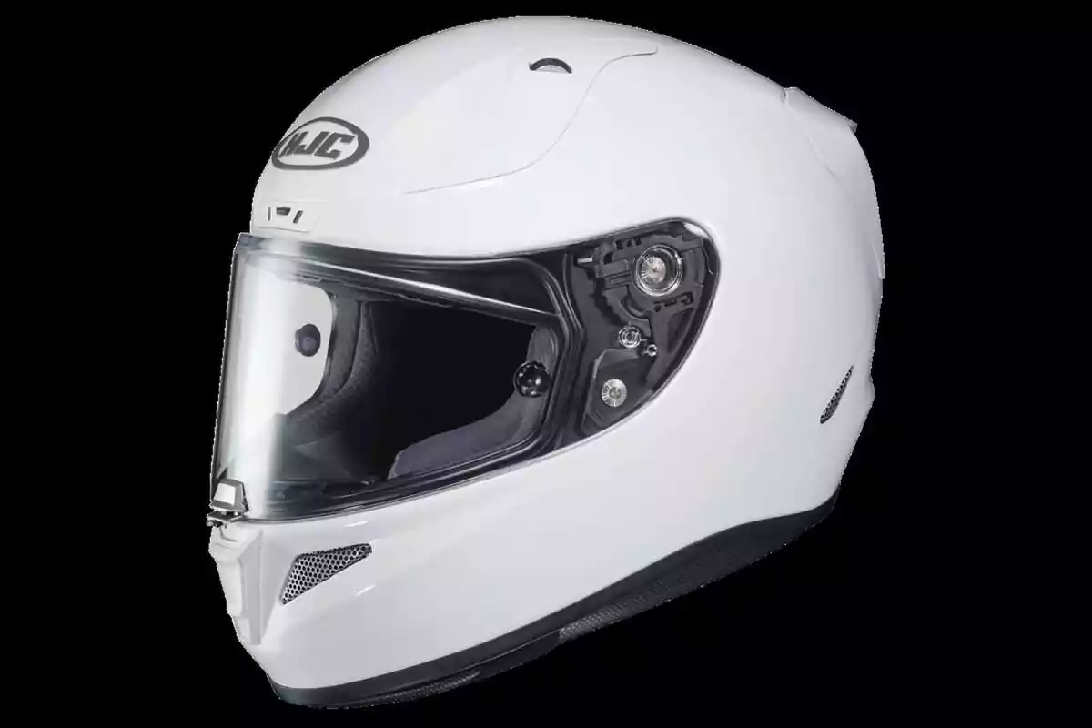 White motorcycle helmet with transparent visor on black background White motorcycle helmet with transparent visor on black background