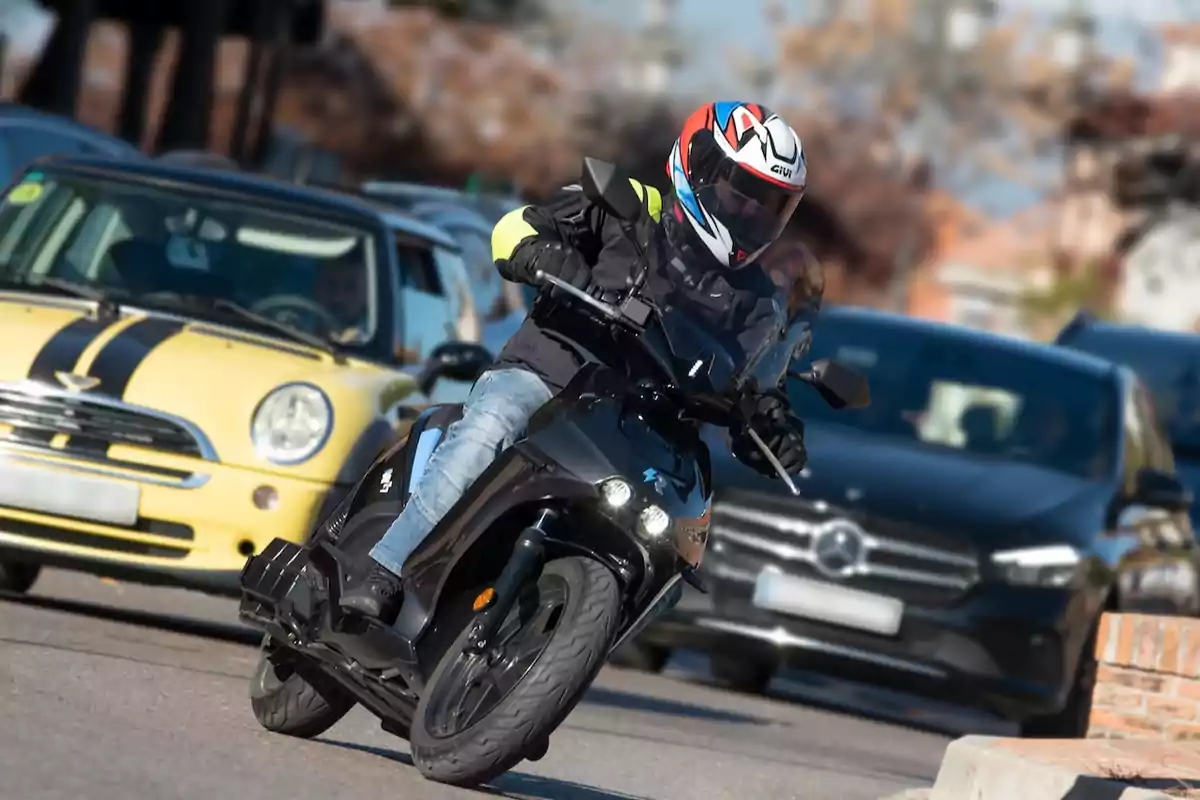 Person riding a black motorcycle with a helmet and jacket, weaving between cars on an urban street