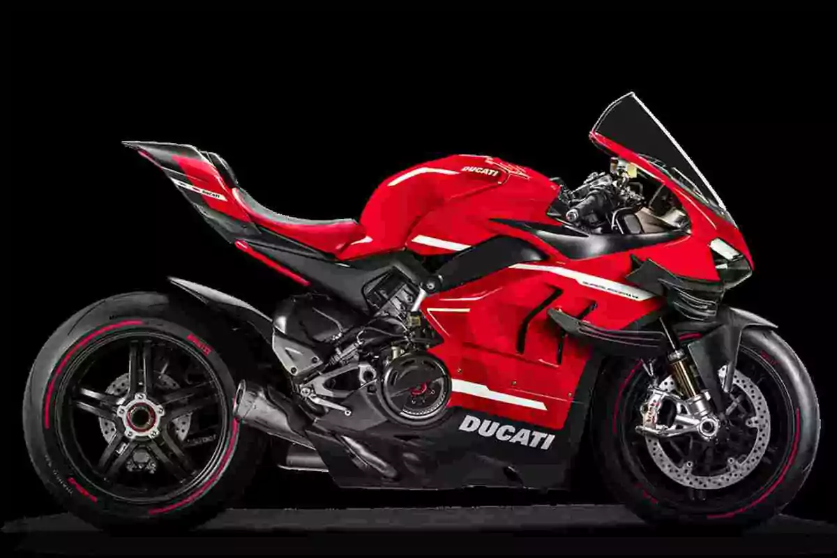 Motocicleta esportiva Ducati vermella amb detalls en blanc i negre sobre un fons negre Motocicleta esportiva Ducati vermella amb detalls en blanc i negre sobre un fons negre