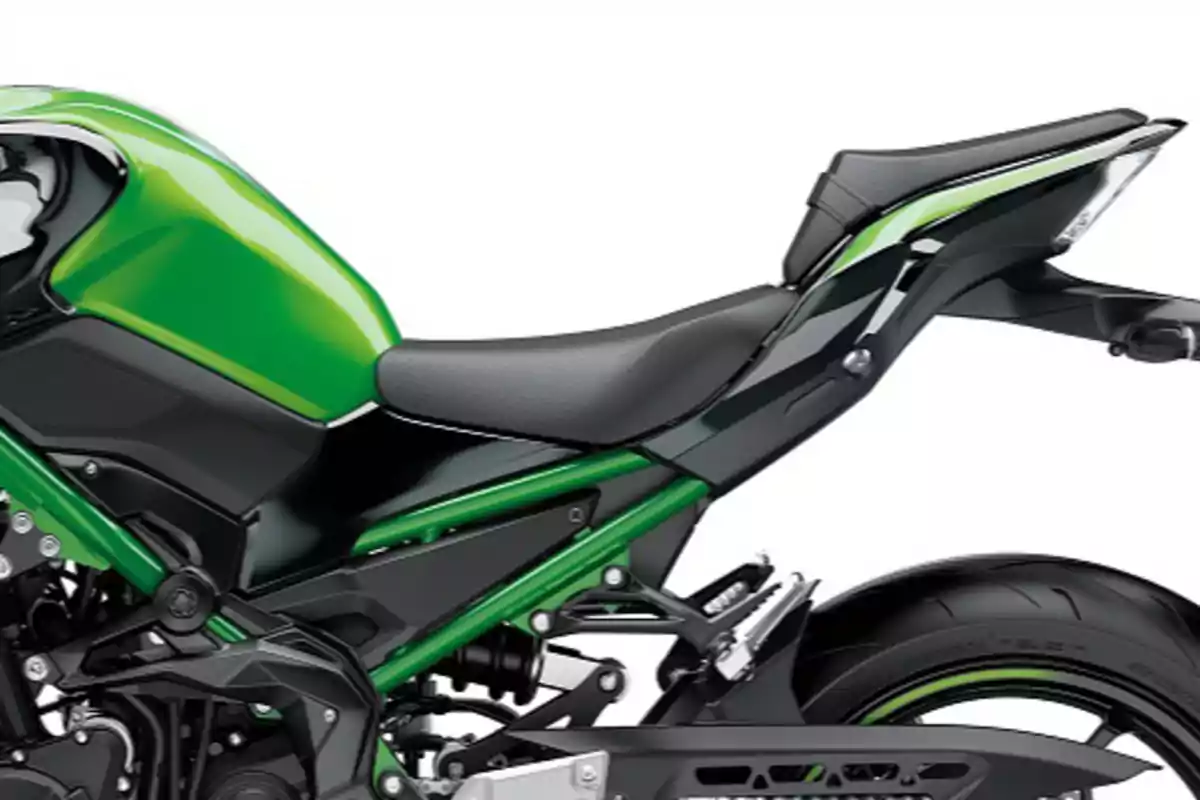 Rear part of a green and black sport motorcycle with visible seat and rear tire Rear part of a green and black sport motorcycle with visible seat and rear tire