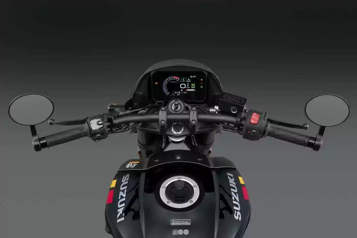 Vista desde el asiento de una motocicleta Suzuki mostrando el manillar, los espejos laterales y el tablero digital encendido Vista desde el asiento de una motocicleta Suzuki mostrando el manillar, los espejos laterales y el tablero digital encendido