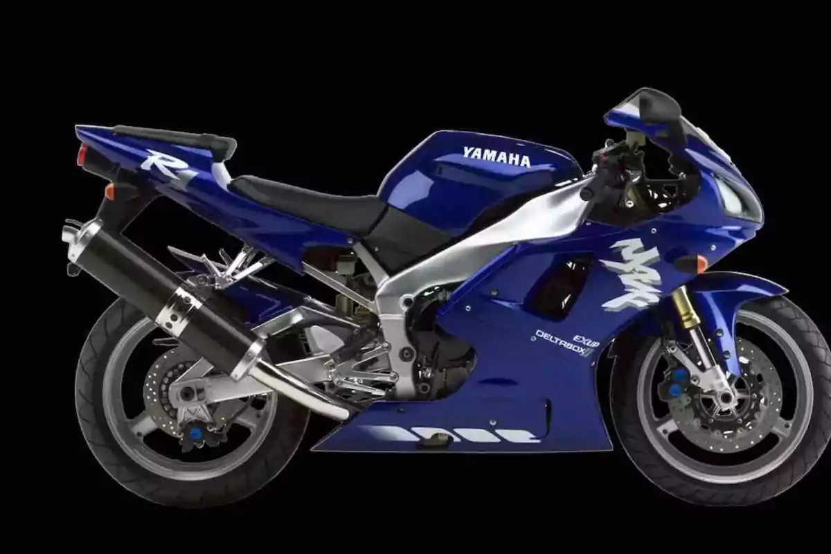 Motocicleta deportiva Yamaha R1 de color azul con detalles en blanco y negro sobre un fondo negro Motocicleta deportiva Yamaha R1 de color azul con detalles en blanco y negro sobre un fondo negro